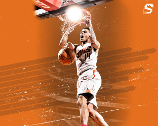 Basketball player dunking basketball hoop - a basketball in the air free wallpaper