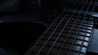 Guitar neck strings dark room - a close up of a guitar neck free wallpaper
