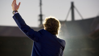 Man suit hands raised air - a stadium in the background free wallpaper