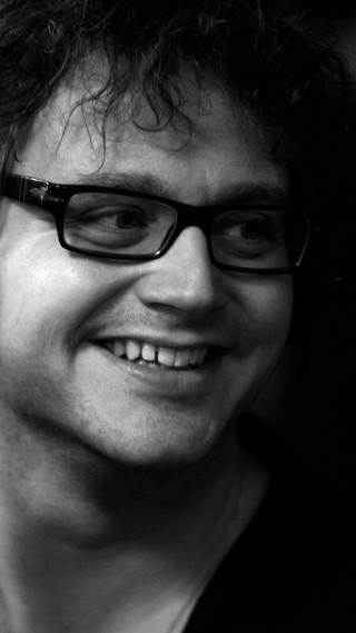 Man glasses smiling cellphone photorealism - his other hand free wallpaper for mobile