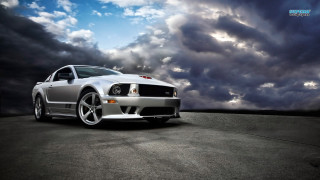 Silver mustang parking lot cloudy 2 - a parking lot under a cloudy sky free wallpaper
