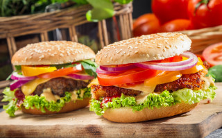 Two hamburgers with lettuce - a cutting board next free wallpaper