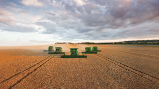 Large field green tractors cloudy - a large field free wallpaper
