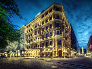 Large building clock nighttime city - a cobblestone street free wallpaper