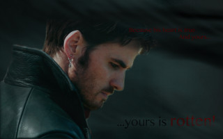 Man ear piercings looking down - dark shadow free wallpaper