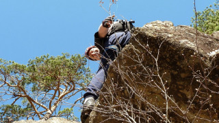 Man climbing rock backpack camera - a backpack free wallpaper