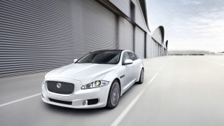 White car driving street building 3 - a garage door free wallpaper