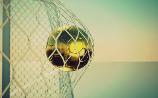 Soccer ball stuck in net 2 - a soccer ball free wallpaper