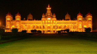 Large building clock tower nighttime 2 - a grassy area in front free wallpaper