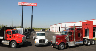 Semi trucks parked storefront kenworth - the side of the building free wallpaper