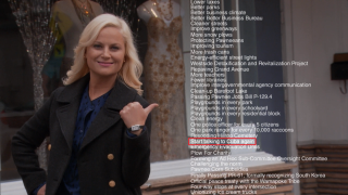 Woman black coat thumbs up - front of a building free wallpaper