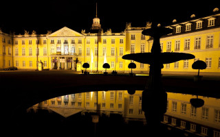 Large building fountain night reflection - a fountain in front free wallpaper