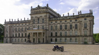 Motorcycle parked large building front - arnold brügger free wallpaper