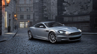 Silver car cobblestone street night - a street light in the background free wallpaper