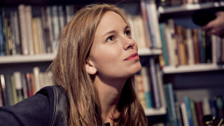 Woman looking up book shelf - a book shelf free wallpaper