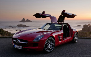 Red sports car ocean sunset - the side of the road near the ocean free wallpaper