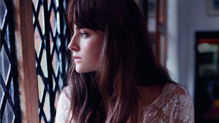 Woman looking out window serious - her face and shoulder free wallpaper