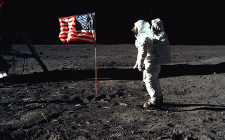 Astronaut standing moon flag surface 2 - an astronaut free wallpaper