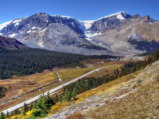 Mountain road valley scenic view - a mountain range in the distance free wallpaper