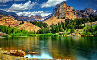Mountain lake surrounded trees cloudy - a mountain lake free wallpaper
