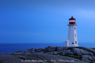 Lighthouse rocky shore ocean night - the ocean in the background free wallpaper for desktop