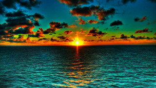 Sunset ocean clouds boat water 2 - the water below free wallpaper