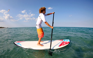 Woman surfboard ocean paddle paddleboard - a surfboard in the ocean free wallpaper