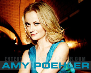 Woman blue dress posing arms 2 - a brick wall in the background free wallpaper