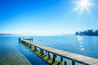 Dock lake blue sky sun - a small island in the distance free wallpaper