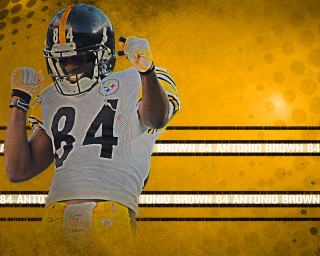 Football player holding ball yellow - a football player holding free wallpaper