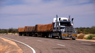 Truck trailer driving road brown - heavy grain free wallpaper