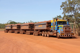 Truck hauling logs dirt road - albert namatjira free wallpaper