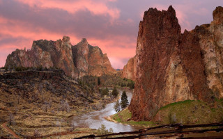 River lush valley pink sky - a mountain range in the distance free wallpaper