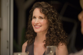 Woman sitting table glass wine - behind her free wallpaper