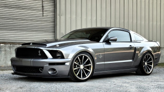 Silver mustang parked building garage - chrome free wallpaper