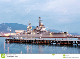 Battleship dock pier water mountains - dusk time free wallpaper