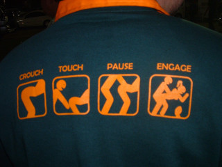 Man green shirt orange lettering - a picture of a man holding free wallpaper