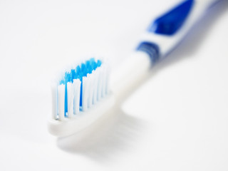 Toothbrush blue white bristles closeup - a white background free wallpaper