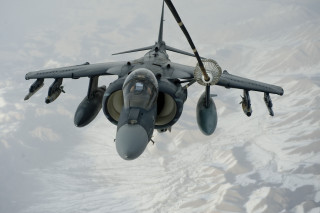 Fighter jet flying mountains snow - the ground below free wallpaper