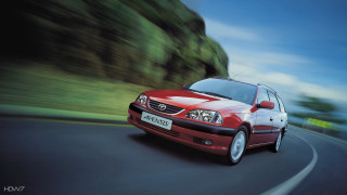 Red car driving road green 2 - a red car free wallpaper