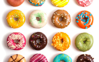 Dozen donuts arranged row white - professional food photography free wallpaper