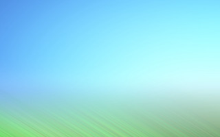 Blurry blue sky green field - a green field in the foreground free wallpaper