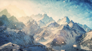 Snowy mountain range sun clouds - a bright sun free wallpaper