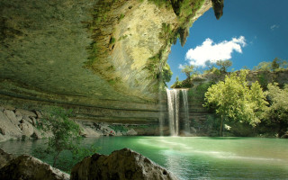Waterfall river blue sky nature - a waterfall in the background free wallpaper for desktop