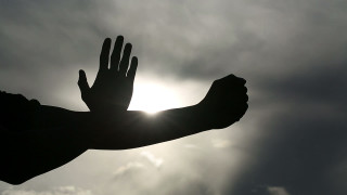 Outstretched hand sun clouds dark - a dark sky free wallpaper