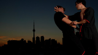 Two men dancing city skyline - their hand together free wallpaper