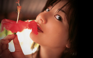 Woman holding flower mouth looking - the flower free wallpaper