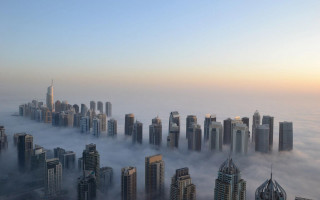 Foggy city skyscrapers clouds background - a foggy sky free wallpaper
