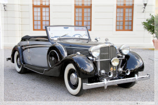 Black car parked building white - art deco free wallpaper