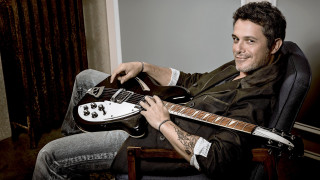 Man chair guitar smiling camera - a chair holding free wallpaper for desktop